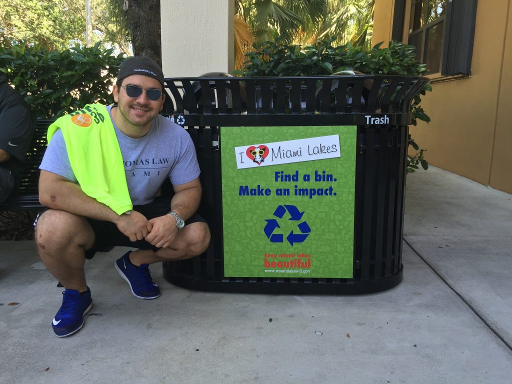 Josh With a newly installed anti-litter sign in 2016 which was an initiative launched while Chair of the Neighborhood Improvement Committee.