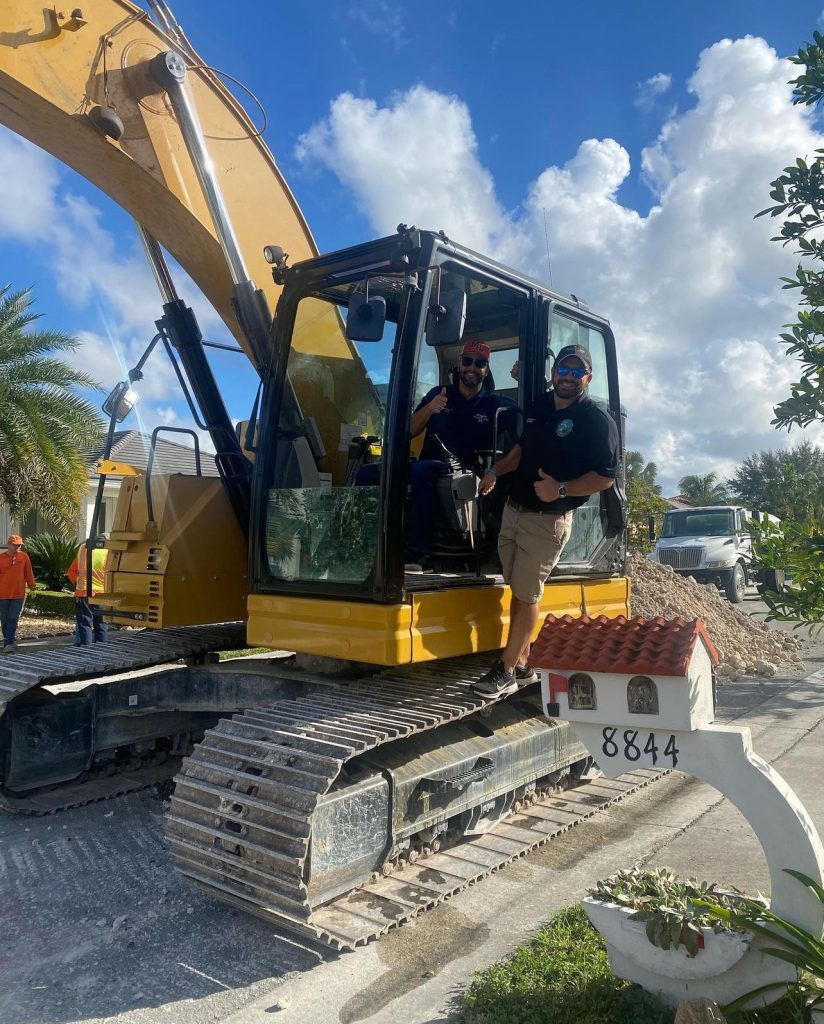 Josh standing on an earth moving machine